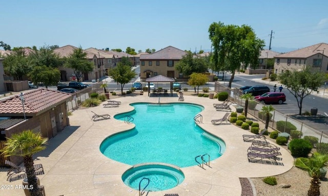 view of swimming pool with a hot tub, a gazebo, and a patio