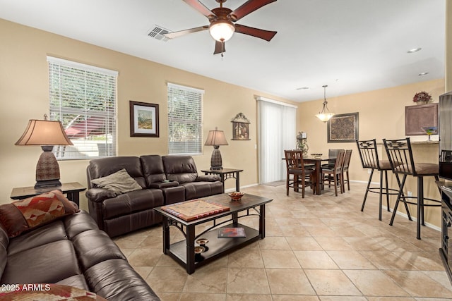 living room with light tile patterned floors and ceiling fan