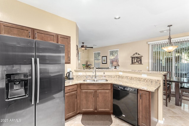 kitchen featuring sink, stainless steel fridge, kitchen peninsula, and black dishwasher