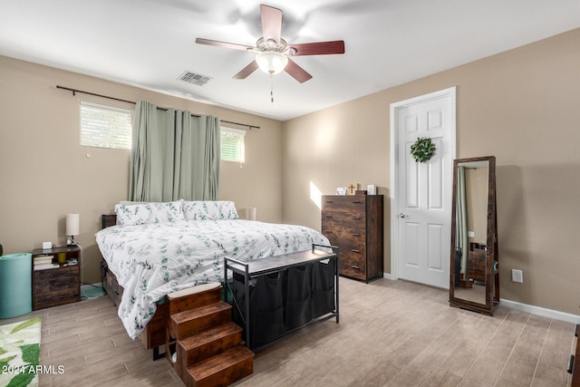 bedroom with light hardwood / wood-style floors and ceiling fan