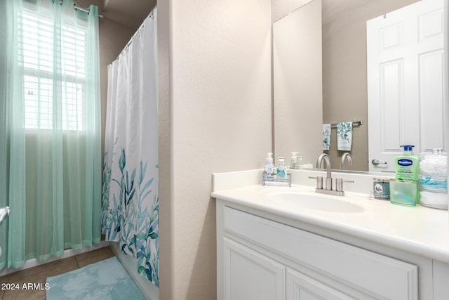 bathroom featuring vanity, tile patterned floors, and curtained shower