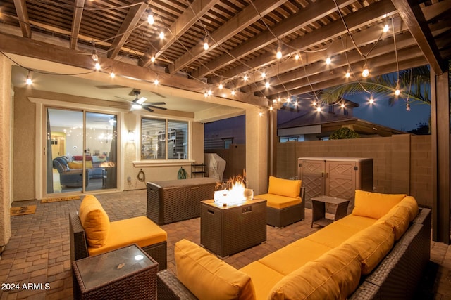 view of patio with an outdoor living space with a fire pit