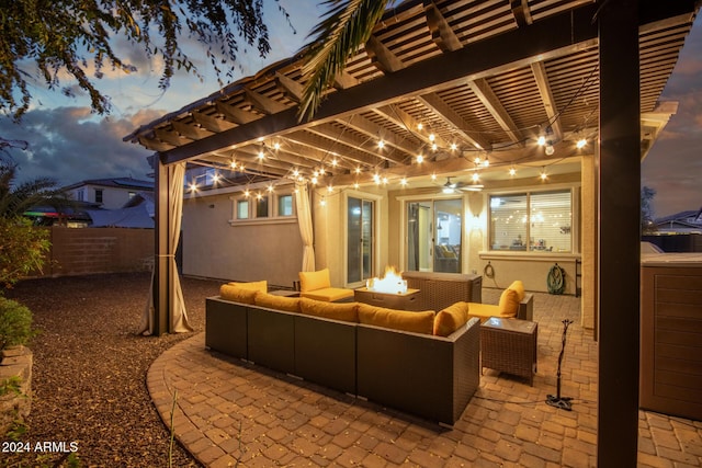 patio terrace at dusk featuring a pergola and an outdoor living space with a fire pit