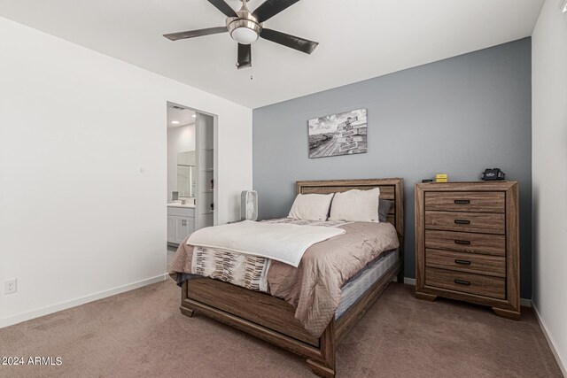 carpeted bedroom featuring ensuite bath and ceiling fan