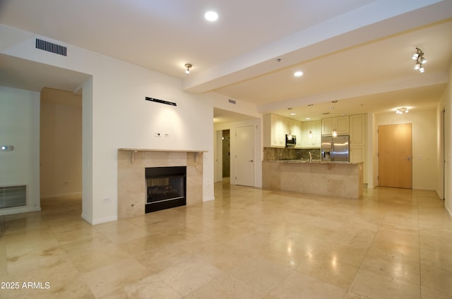 unfurnished living room with a tile fireplace