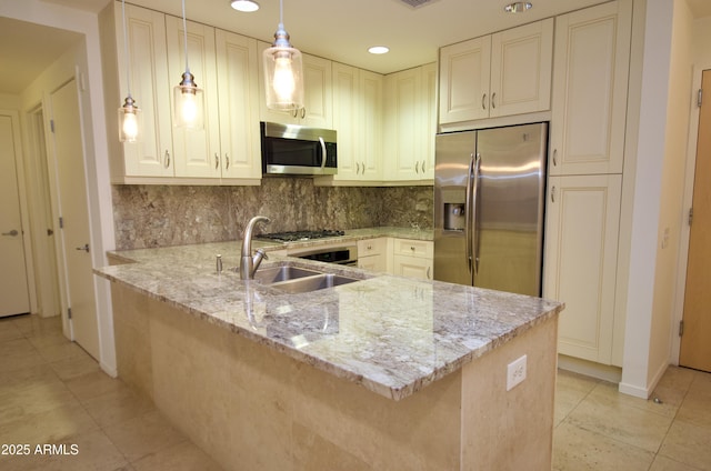 kitchen featuring sink, decorative light fixtures, kitchen peninsula, stainless steel appliances, and light stone countertops