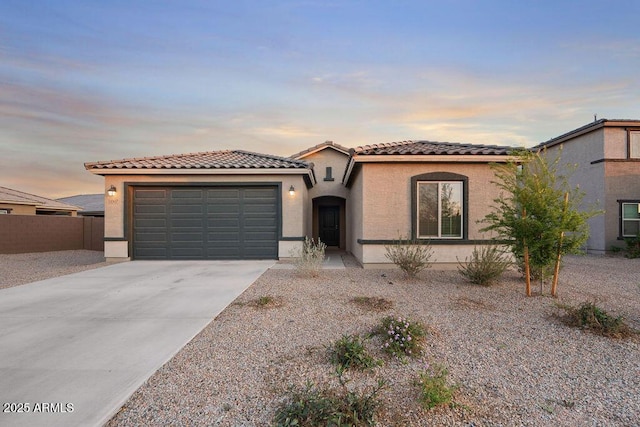 43637 W Cypress Ln, Maricopa, AZ 85138 - mediterranean / spanish-style home featuring driveway, stucco siding, an attached garage, and a tiled roof