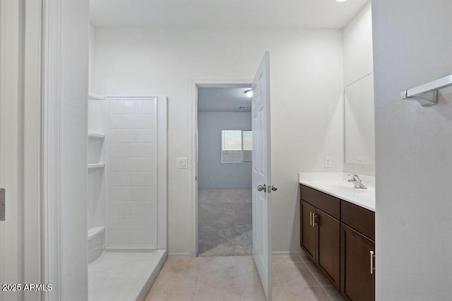 43637 W Cypress Ln, Maricopa, AZ 85138 - bathroom with tile patterned floors, vanity, baseboards, and walk in shower