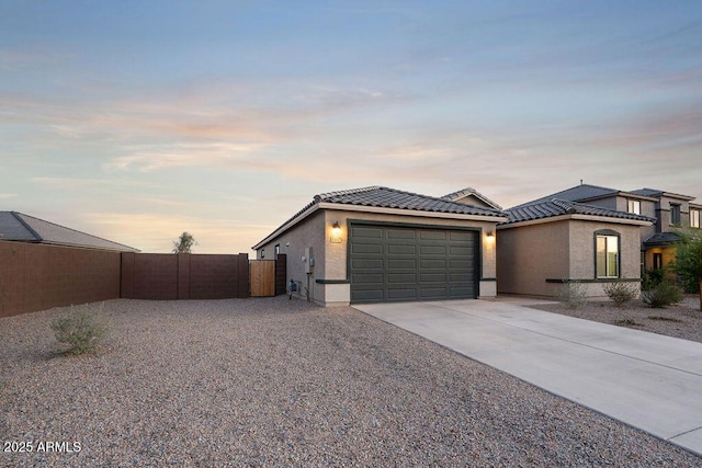 43637 W Cypress Ln, Maricopa, AZ 85138 - view of front facade featuring a tiled roof, driveway, stucco siding, and an attached garage