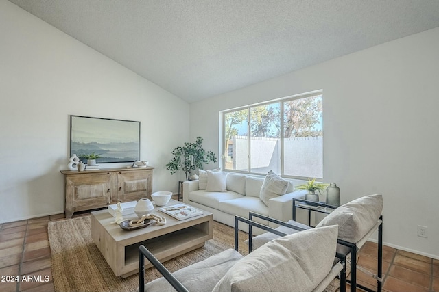 tiled living room featuring a textured ceiling and lofted ceiling