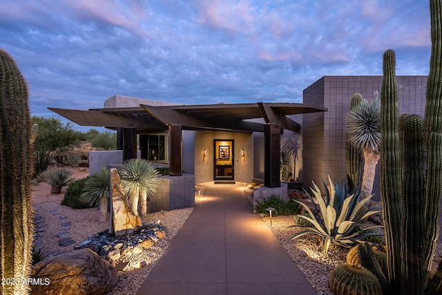 view of exterior entry at dusk