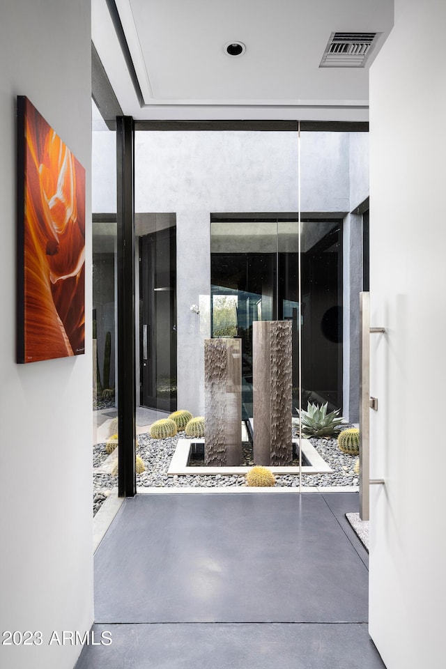 doorway featuring expansive windows and concrete floors