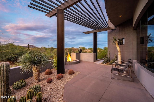 patio terrace at dusk with a pergola and a fire pit