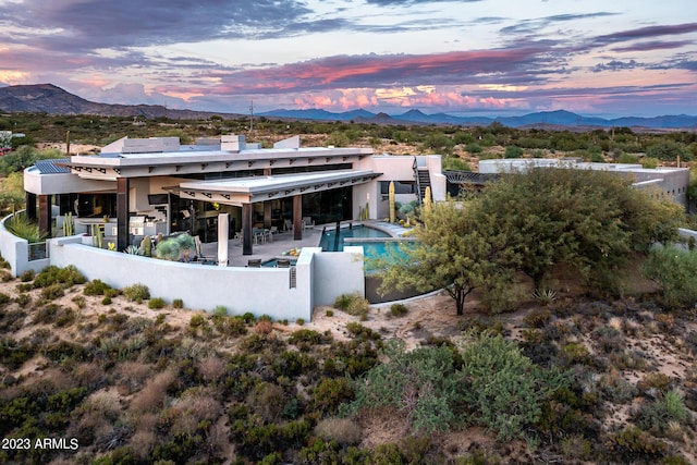 back house at dusk featuring a mountain view