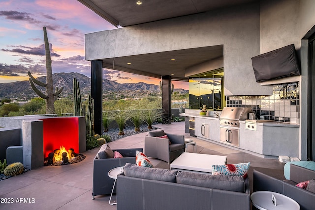 view of patio / terrace featuring area for grilling, a mountain view, grilling area, and an outdoor living space