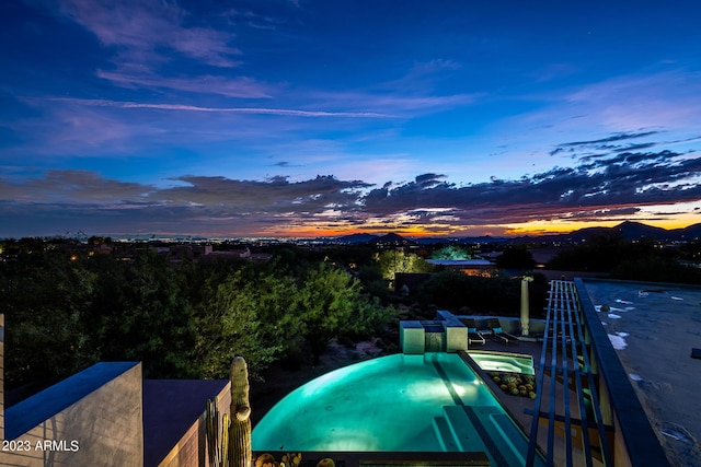 pool at dusk with a mountain view