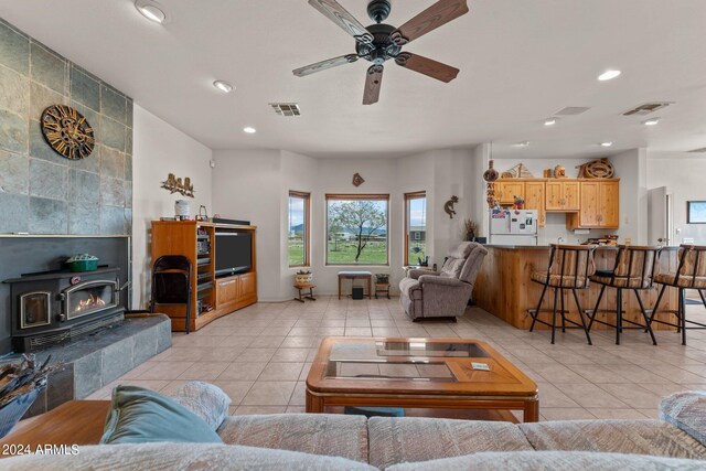 22900 W Hylton Way, Congress, AZ 85332 - tiled living room featuring a wood stove and ceiling fan