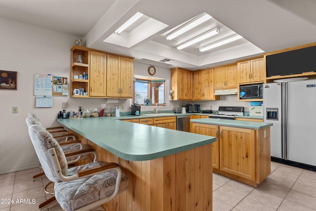 22900 W Hylton Way, Congress, AZ 85332 - kitchen featuring kitchen peninsula, light tile patterned flooring, a kitchen island, light brown cabinetry, and white appliances