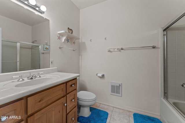 22900 W Hylton Way, Congress, AZ 85332 - full bathroom with heating unit, tile patterned floors, vanity, toilet, and combined bath / shower with glass door