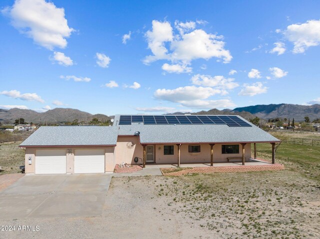 22900 W Hylton Way, Congress, AZ 85332 - ranch-style house with a garage, solar panels, and a mountain view