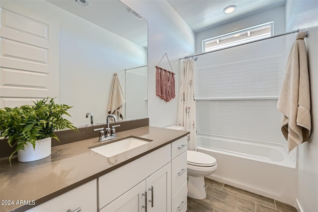 full bathroom with shower / bath combo, vanity, hardwood / wood-style flooring, and toilet