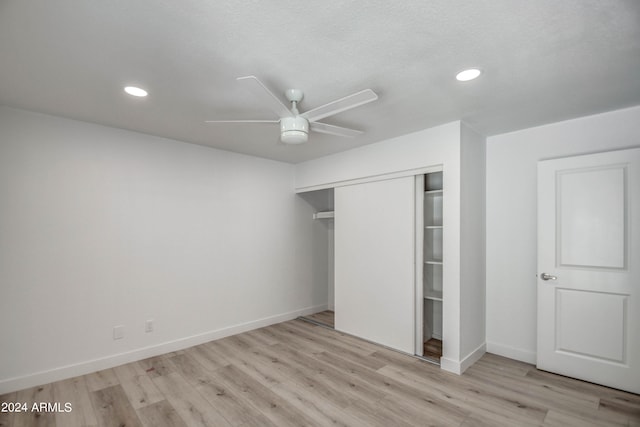 unfurnished bedroom with ceiling fan, a closet, and light hardwood / wood-style floors