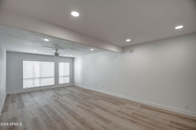 spare room featuring ceiling fan and light hardwood / wood-style flooring