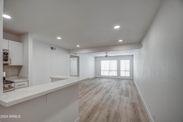 unfurnished living room with light hardwood / wood-style floors and ceiling fan