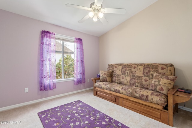 living area with lofted ceiling, light colored carpet, and ceiling fan