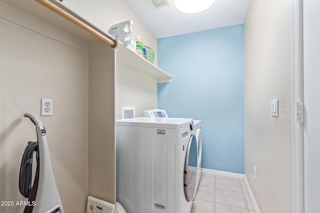 laundry area featuring light tile patterned flooring and separate washer and dryer