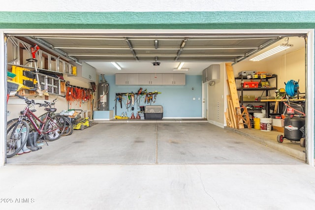 garage with a workshop area and water heater