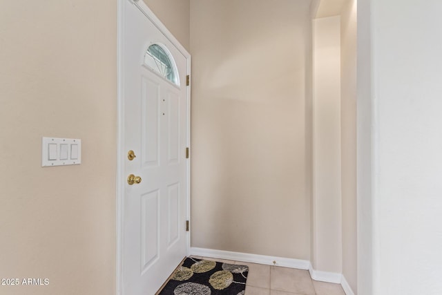 doorway to outside with light tile patterned floors