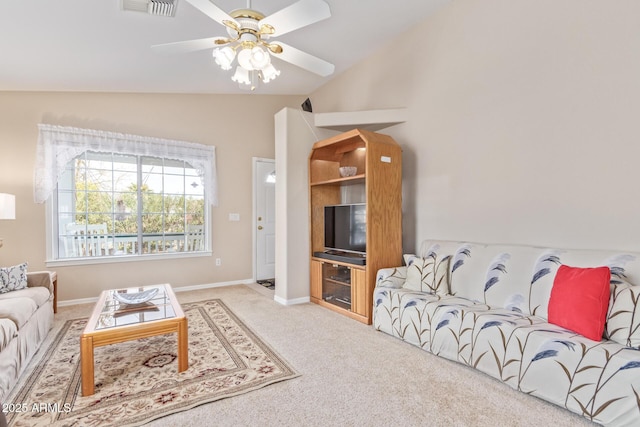 carpeted living room with ceiling fan and lofted ceiling