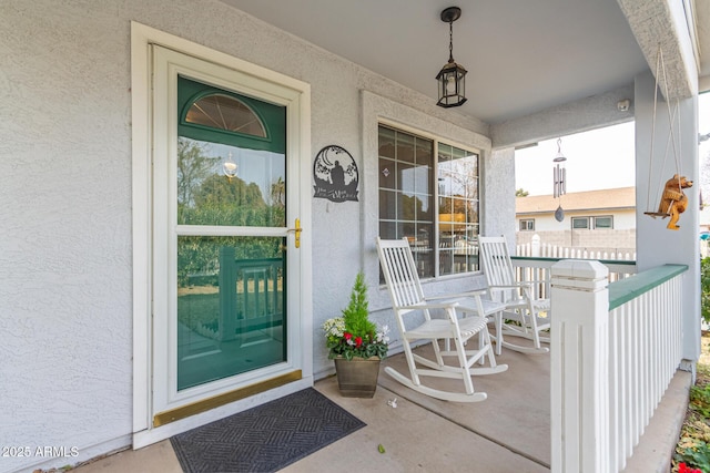 doorway to property featuring covered porch