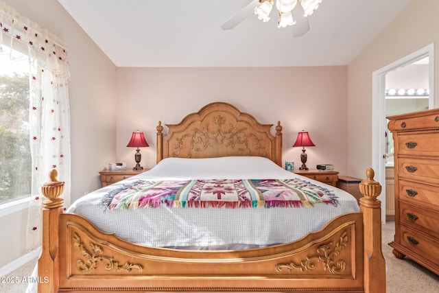 bedroom with multiple windows, light colored carpet, and ceiling fan