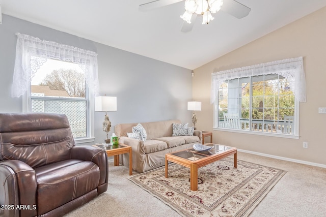 carpeted living room with ceiling fan and lofted ceiling