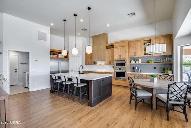 kitchen featuring a sink, visible vents, and open shelves