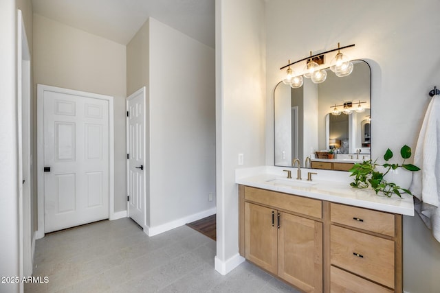 bathroom with vanity and baseboards