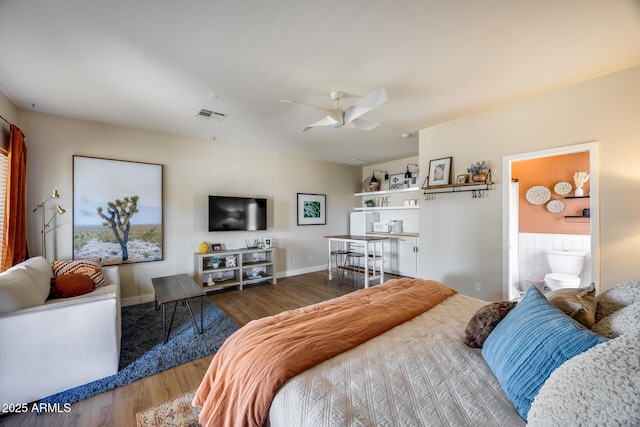 bedroom with visible vents, ceiling fan, and wood finished floors