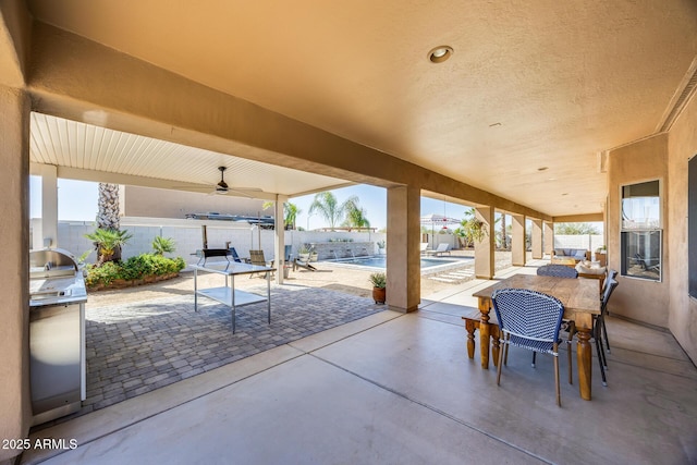 view of patio with outdoor dining space, a fenced backyard, and a fenced in pool