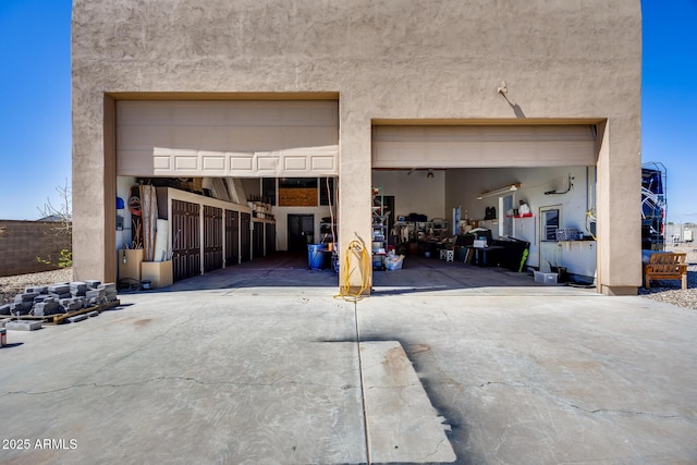 garage featuring concrete driveway