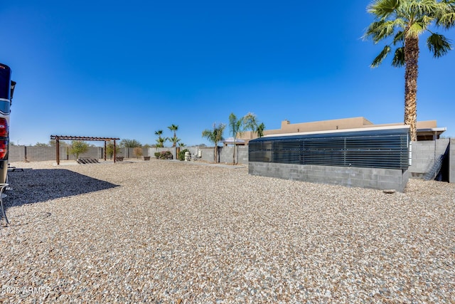 view of yard with a fenced backyard and a pergola