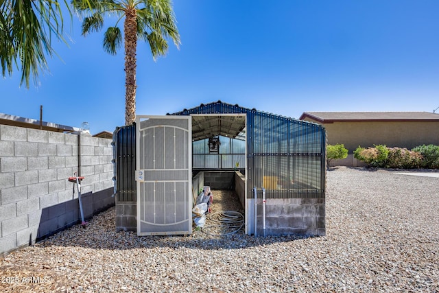 view of greenhouse with fence