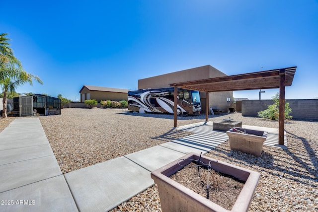 view of yard featuring fence and an outdoor fire pit