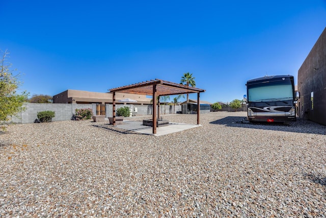 view of yard with a patio area, a shed, an outdoor structure, and a fenced backyard