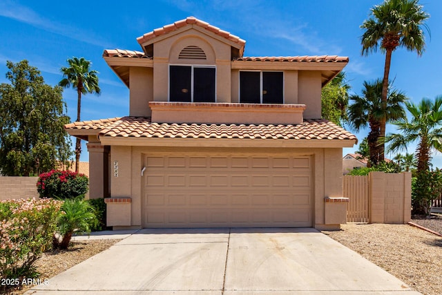 7702 W Piute Ave, Glendale, AZ 85308 - mediterranean / spanish house featuring an attached garage, driveway, a tile roof, and stucco siding