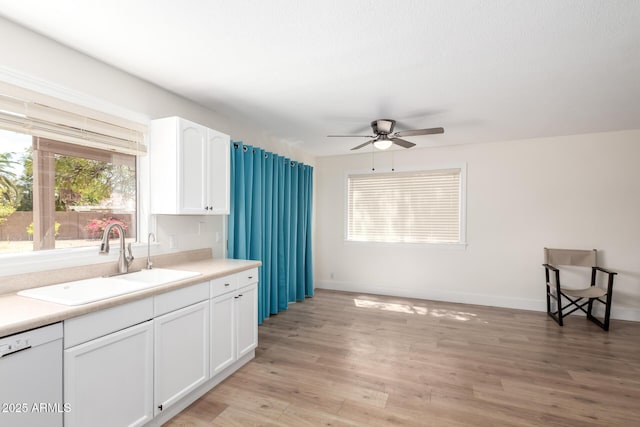 7702 W Piute Ave, Glendale, AZ 85308 - kitchen featuring a sink, dishwasher, ceiling fan, white cabinetry, and light wood-type flooring