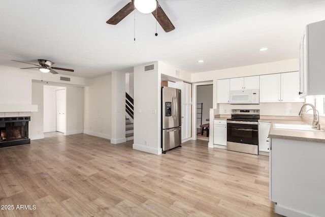 7702 W Piute Ave, Glendale, AZ 85308 - kitchen featuring appliances with stainless steel finishes, ceiling fan, a sink, open floor plan, and light countertops