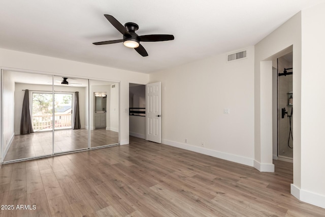 7702 W Piute Ave, Glendale, AZ 85308 - unfurnished bedroom featuring light wood-type flooring, baseboards, ceiling fan, and ensuite bathroom
