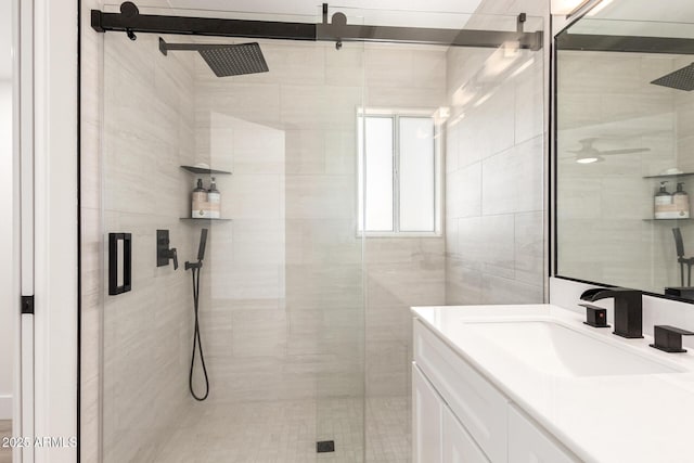 7702 W Piute Ave, Glendale, AZ 85308 - bathroom featuring a shower stall, vanity, and tile walls